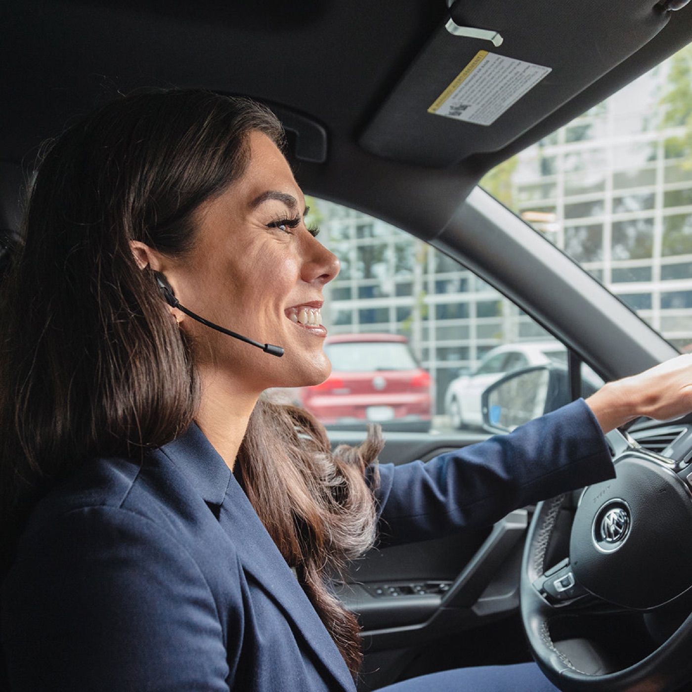 Work Buds earbud with boom mic, on a call in the car